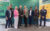 Acht Personen stehen zum Gruppenfoto vor einer Hintergrundwand mit emergenCITY- und DiReX-Logos.